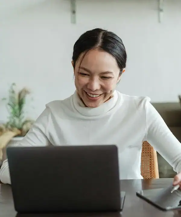 woman smiling at laptop