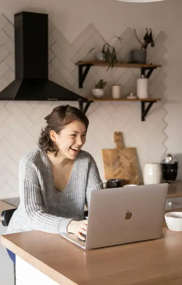 woman smiling on laptop video call